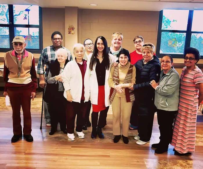 Dr. Quinee with community members — health education in action